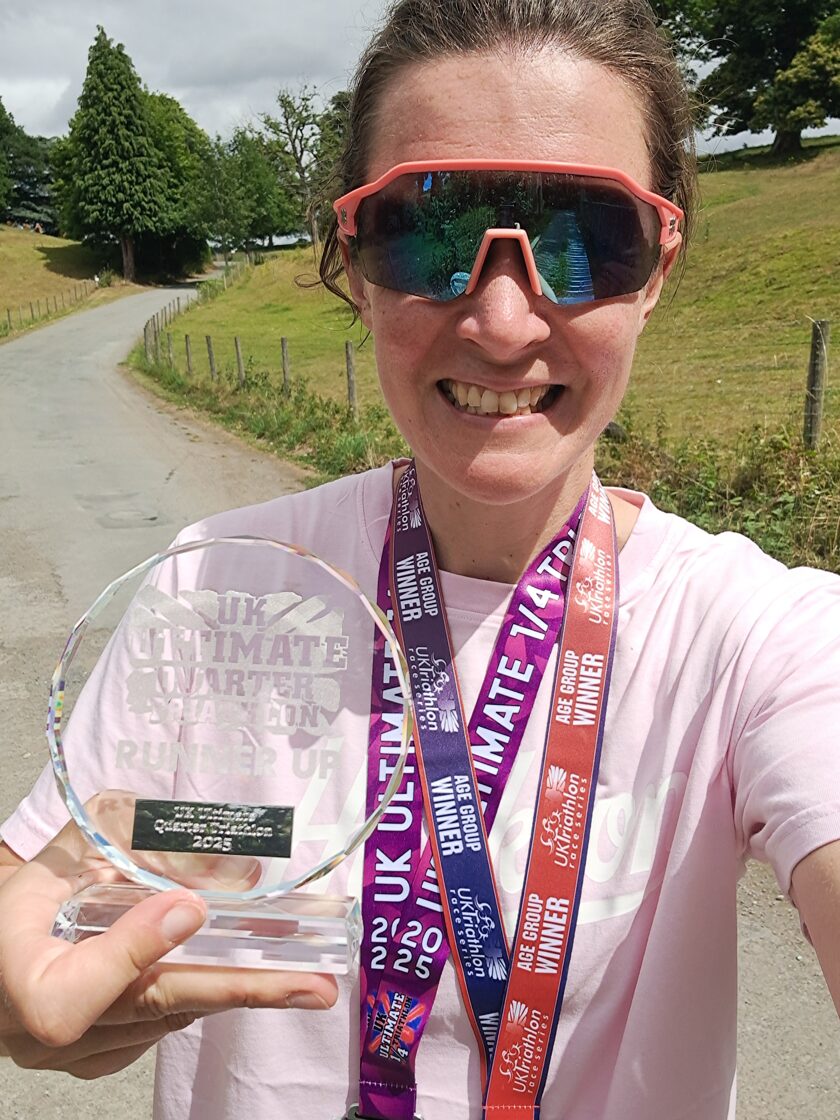 Ellie Perkins with her medals at Ellesmere Lake during the Quarter Ultimate Triathlon